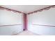 Vacant bedroom with a wallpaper border, open closet, and interior door at 613 Barrett St, Danville, IN 46122