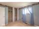 Spare bedroom with open closet, window, and blue curtains at 613 Barrett St, Danville, IN 46122