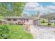A quaint single-story house with a covered parking area and a green lawn at 613 Barrett St, Danville, IN 46122