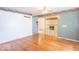 An expansive living room showcasing beautiful hardwood floors and open access to the brick fireplace room at 613 Barrett St, Danville, IN 46122