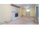 A bright living room features a painted brick fireplace and a ceiling fan at 613 Barrett St, Danville, IN 46122