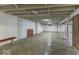 Unfinished basement with a concrete floor, red bench and brick pillars at 6204 S Madison Ave, Indianapolis, IN 46227