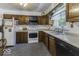 Functional kitchen with wood cabinetry, white countertops, and essential appliances at 6204 S Madison Ave, Indianapolis, IN 46227