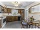 Traditional kitchen features wood cabinets, white appliances, and an adjacent dining area at 6204 S Madison Ave, Indianapolis, IN 46227