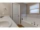 Bright bathroom featuring a marble accented tub, neutral walls, and a double sink vanity at 6615 Aberdeen Dr, McCordsville, IN 46055