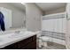 Clean bathroom with a single sink vanity, toilet, and a shower with a striped curtain at 6615 Aberdeen Dr, McCordsville, IN 46055