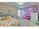 Cozy carpeted bedroom with a floral bedspread, lavender accent wall, and plenty of natural light at 6615 Aberdeen Dr, McCordsville, IN 46055