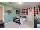 This bedroom includes carpet floors, a bed with a light gray stripped cover, and sports themed decor at 6615 Aberdeen Dr, McCordsville, IN 46055