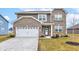 Charming two-story home with a brick and siding exterior, two car garage, and well maintained landscaping at 6615 Aberdeen Dr, McCordsville, IN 46055