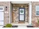 Close up of the front door with welcome sign, wreath, house number, and stone wall at 6615 Aberdeen Dr, McCordsville, IN 46055
