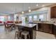 Open kitchen with granite countertops, dark cabinets, stainless steel appliances, and island with seating at 6615 Aberdeen Dr, McCordsville, IN 46055
