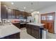Well-lit kitchen with stainless appliances, granite countertops, center island and modern cabinets at 6615 Aberdeen Dr, McCordsville, IN 46055