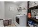 Laundry room with a washing machine, dryer, storage shelves, and light gray colored walls at 6615 Aberdeen Dr, McCordsville, IN 46055