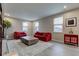 Cozy living room with natural light features red sofas, a rustic coffee table, and stylish decor at 6615 Aberdeen Dr, McCordsville, IN 46055