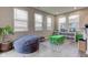 Bright playroom featuring large windows, a cozy beanbag chair, and a kid-friendly table and chairs at 6615 Aberdeen Dr, McCordsville, IN 46055