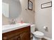 Clean powder room featuring a modern vanity, round mirror, and toilet at 6615 Aberdeen Dr, McCordsville, IN 46055
