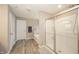 Bright bathroom features a glass shower, soaking tub and wood-look floors at 6699 Dunkirk Dr, McCordsville, IN 46055