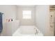 Bright bathroom features a soaking tub with a window and a shower at 6699 Dunkirk Dr, McCordsville, IN 46055