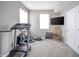 Well lit exercise room with windows and a TV at 6699 Dunkirk Dr, McCordsville, IN 46055
