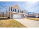 Two-story home featuring a spacious driveway leading to a two-car garage and inviting front porch at 6699 Dunkirk Dr, McCordsville, IN 46055