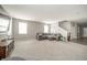 Spacious living room with plush gray furniture and neutral carpet, offering a comfortable and inviting atmosphere at 6699 Dunkirk Dr, McCordsville, IN 46055