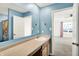 Blue bathroom featuring a spacious counter and mirror with a view into the bedroom at 6895 Honeysuckle Way, Pendleton, IN 46064