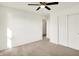 Bright bedroom with soft gray carpet, ceiling fan and double closets at 6895 Honeysuckle Way, Pendleton, IN 46064