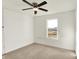 Bright bedroom with soft gray carpet, ceiling fan and a single window at 6895 Honeysuckle Way, Pendleton, IN 46064