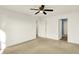 Spacious bedroom with neutral carpet, ceiling fan, and walk-in closet at 6895 Honeysuckle Way, Pendleton, IN 46064