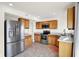 Bright kitchen featuring stainless steel appliances, light wood cabinets, and neutral tile floors at 6895 Honeysuckle Way, Pendleton, IN 46064