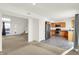 Open-concept living area featuring a kitchen, staircase, and a view of the front door at 6895 Honeysuckle Way, Pendleton, IN 46064