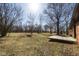 Expansive backyard featuring a wooden deck, mature trees, and a fire pit area, perfect for outdoor enjoyment at 7089 W Us Highway 36, Danville, IN 46122