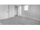 Cozy bedroom featuring gray carpet, neutral walls and trim, a window, and closet at 7089 W Us Highway 36, Danville, IN 46122
