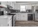 Modern kitchen featuring white cabinets, stainless steel appliances, and luxury vinyl plank flooring at 7089 W Us Highway 36, Danville, IN 46122