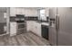 Well-lit kitchen with stainless steel appliances, stylish backsplash, and luxury vinyl plank flooring at 7089 W Us Highway 36, Danville, IN 46122