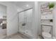 Clean bathroom with a glass-enclosed shower, toilet and built-in shelves for a fresh and tidy space at 737 Oxford Ln, Danville, IN 46122