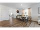 Elegant dining room with a wooden table, stylish chairs, large windows, and hardwood flooring for a warm ambiance at 737 Oxford Ln, Danville, IN 46122
