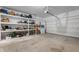 Spacious garage with shelving, storage, and an automatic door at 737 Oxford Ln, Danville, IN 46122