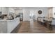 Open-concept kitchen and dining area with modern appliances, a spacious island, and stylish hardwood floors at 737 Oxford Ln, Danville, IN 46122