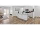 Stylish open-concept kitchen with stainless steel appliances, a center island, and seamless access to the living area at 737 Oxford Ln, Danville, IN 46122