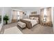 Serene main bedroom featuring a large bed, bench, and decorative curtains for a relaxing retreat at 737 Oxford Ln, Danville, IN 46122