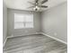 Bedroom features wood-look floors, neutral walls, a window, and a ceiling fan at 741 Southfield Ct, Indianapolis, IN 46227