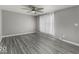 Bedroom features wood-look floors, a ceiling fan, neutral walls, and a large window at 741 Southfield Ct, Indianapolis, IN 46227