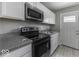 Modern kitchen featuring stainless steel appliances, white cabinets, and gray walls at 741 Southfield Ct, Indianapolis, IN 46227