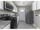 Modern kitchen featuring stainless steel appliances, white cabinets, and gray walls at 741 Southfield Ct, Indianapolis, IN 46227