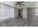 Spacious living room with wood-look floors, a ceiling fan, and neutral walls at 741 Southfield Ct, Indianapolis, IN 46227