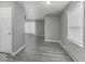 Open-concept living room with wood-look floors, a ceiling fan, and a large window at 741 Southfield Ct, Indianapolis, IN 46227