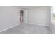 This bedroom is painted with neutral walls, has soft carpet, and a large window for natural light at 8445 Morgan Ln, Zionsville, IN 46077