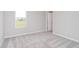 This bedroom offers neutral walls, soft carpet, and a large window for natural light at 8445 Morgan Ln, Zionsville, IN 46077