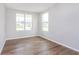 Bright bedroom features wood floors, white walls, and large windows offering neighborhood views at 8445 Morgan Ln, Zionsville, IN 46077